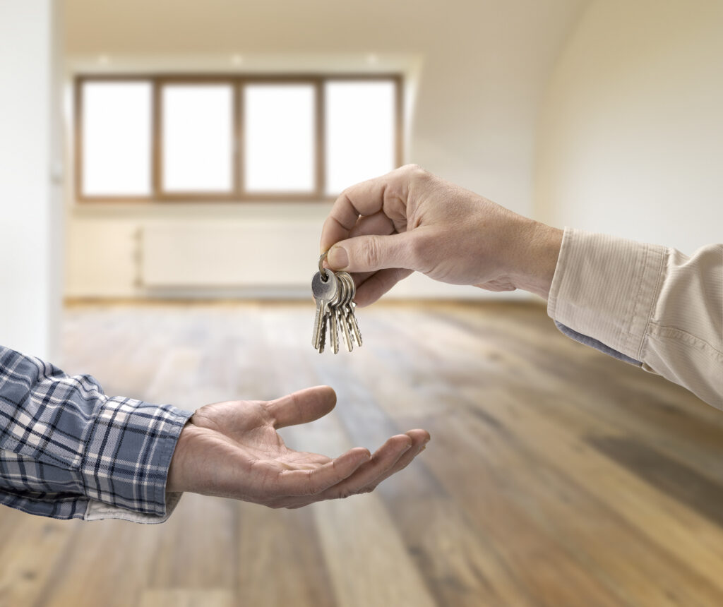 realtor giving house keys to tenant